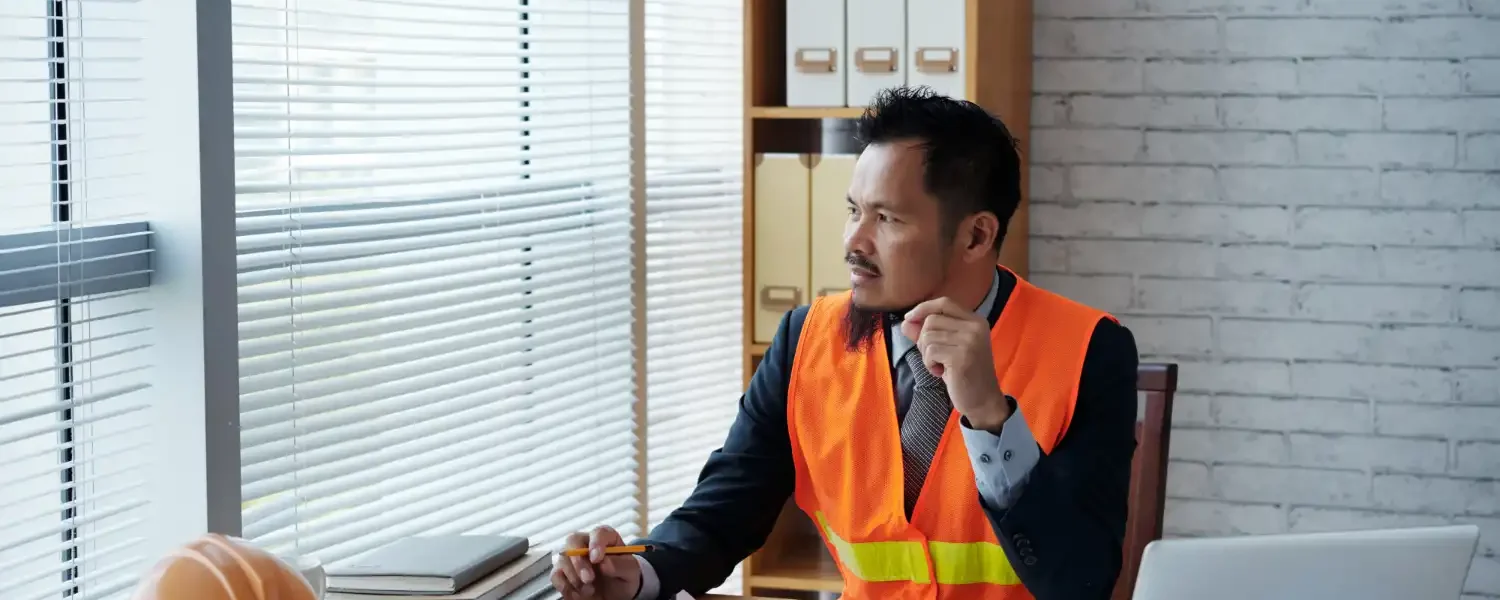 Profissional de segurança do trabalho avaliando ambiente de escritório com versão híbrida, promovendo novos desafios em segurança do trabalho em ambientes híbridos.